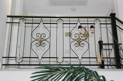 Handrail with Bronze top rail and bronze elements on scrolls